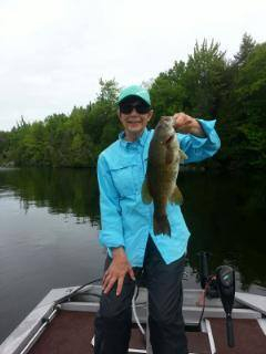 lady in blue with bass from East Grand Lake