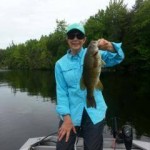 woman holding bass on East Grand Lake